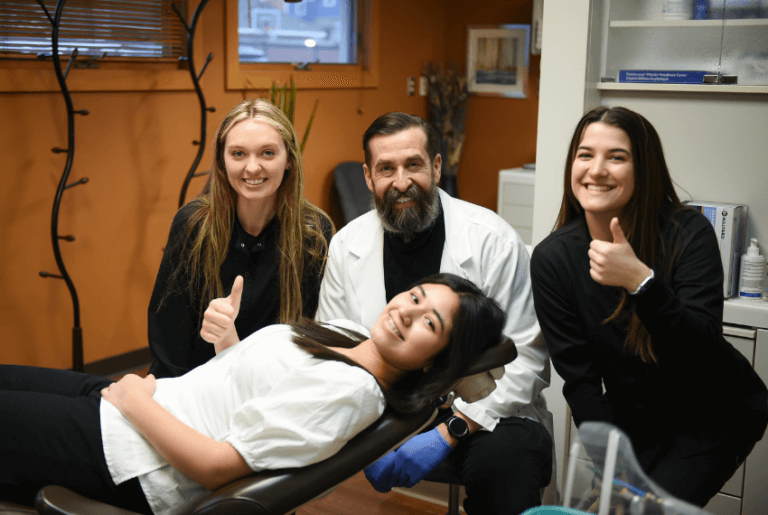 happy patient and Great River Orthodontics team